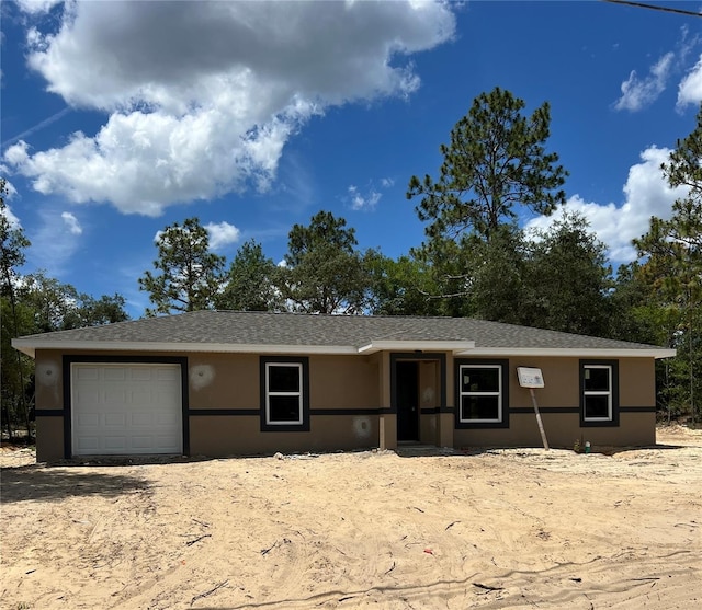21712 SW Rainbow Lakes Blvd, Dunnellon, FL 34431 - view of front of home featuring stucco siding and a garage