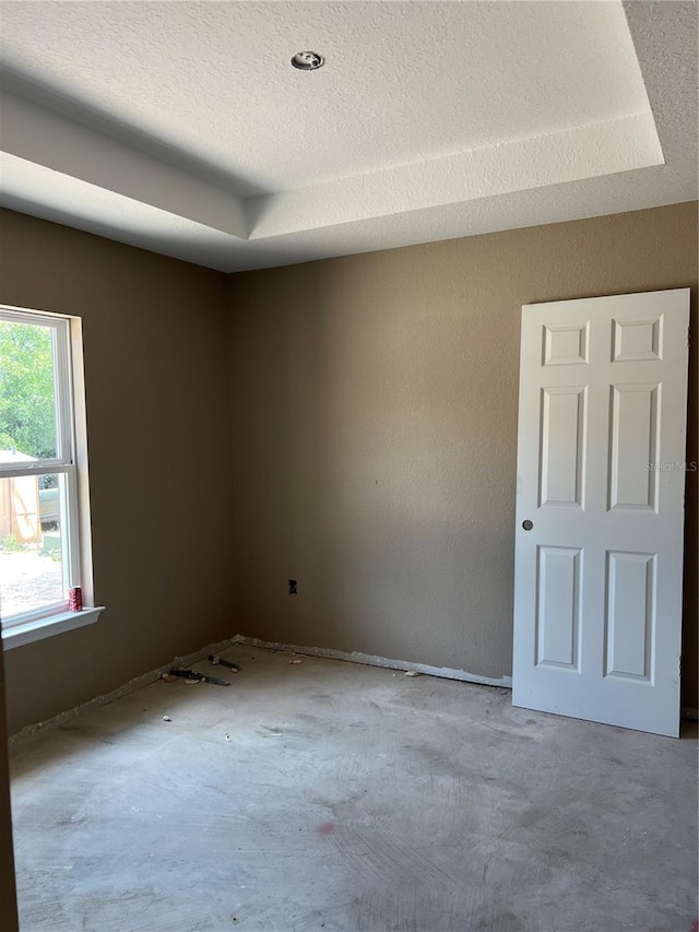 21712 SW Rainbow Lakes Blvd, Dunnellon, FL 34431 - empty room featuring a textured ceiling and a tray ceiling