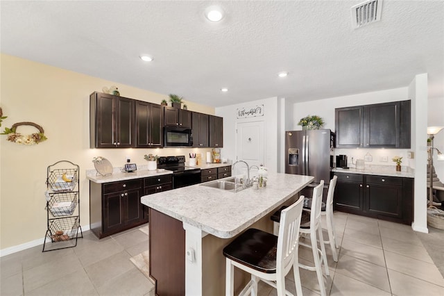 2552 NE 42nd Rd, Ocala, FL 34470 - kitchen featuring black appliances, a kitchen breakfast bar, light countertops, light tile patterned flooring, and recessed lighting