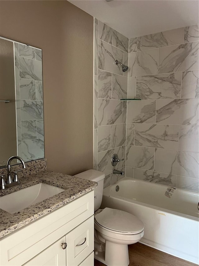 10375 SE 126th Ln, Belleview, FL 34420 - bathroom with vanity, washtub / shower combination, and wood finished floors