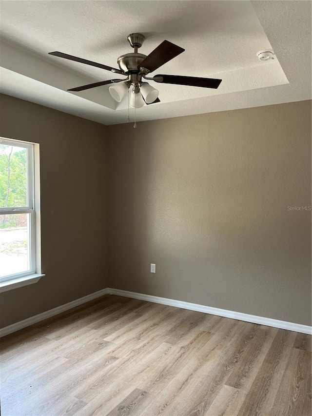 10375 SE 126th Ln, Belleview, FL 34420 - spare room featuring wood finished floors, a textured ceiling, and a ceiling fan