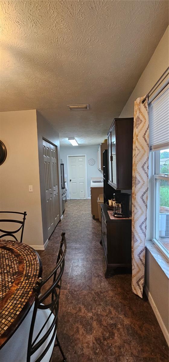 5591 NW 61st Ln, Ocala, FL 34482 - hallway with a textured ceiling