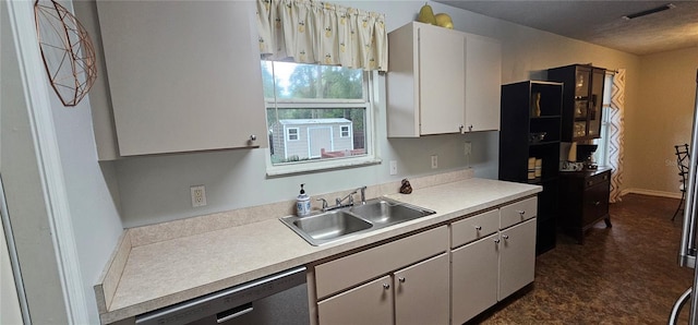 5591 NW 61st Ln, Ocala, FL 34482 - kitchen featuring dishwasher, light countertops, dark floors, and white cabinetry