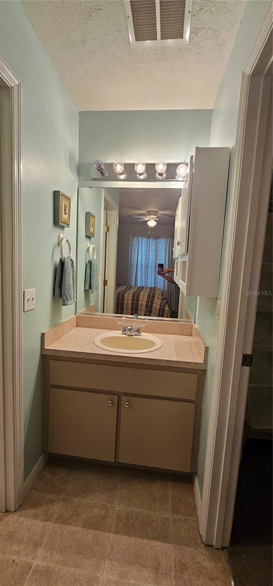 5591 NW 61st Ln, Ocala, FL 34482 - bathroom with vanity and a textured ceiling