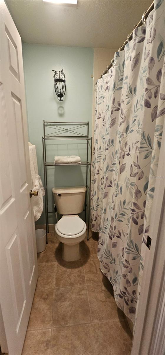 5591 NW 61st Ln, Ocala, FL 34482 - bathroom featuring toilet and curtained shower