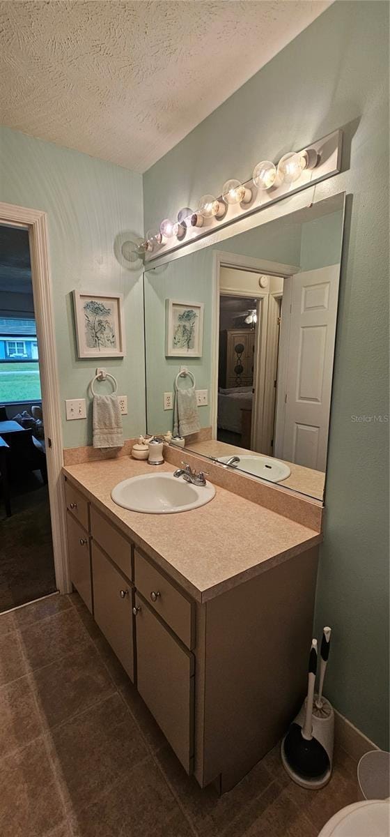 5591 NW 61st Ln, Ocala, FL 34482 - bathroom featuring vanity, a textured ceiling, and tile patterned flooring
