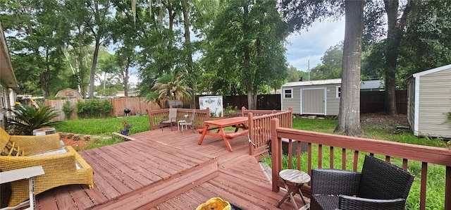 5591 NW 61st Ln, Ocala, FL 34482 - wooden terrace with a storage unit, outdoor dining space, and a fenced backyard