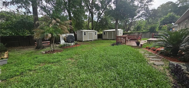5591 NW 61st Ln, Ocala, FL 34482 - view of yard featuring a storage shed, a deck, and view of scattered trees