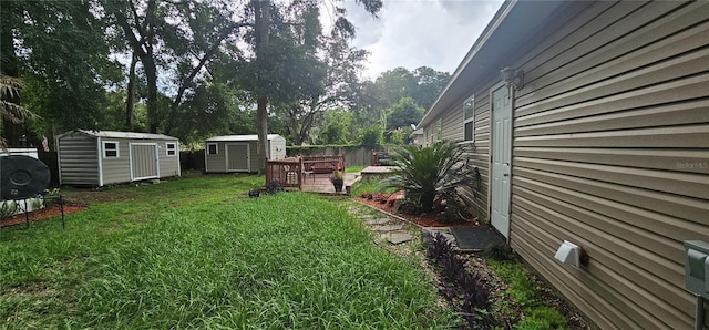 5591 NW 61st Ln, Ocala, FL 34482 - view of green lawn featuring a storage shed and a wooden deck