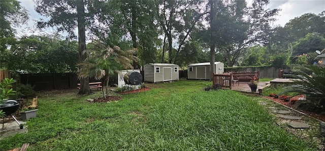 5591 NW 61st Ln, Ocala, FL 34482 - fenced backyard featuring a shed, a deck, and view of wooded area