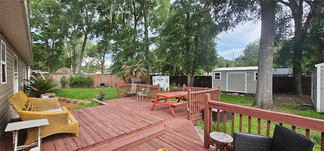 5591 NW 61st Ln, Ocala, FL 34482 - deck featuring a storage shed, a fenced backyard, and outdoor dining space
