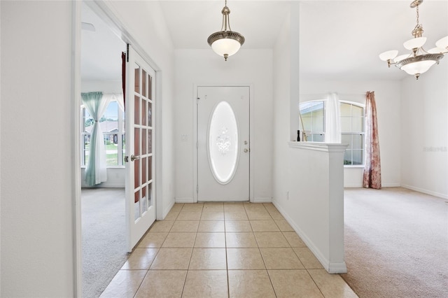 4300 NW 4th Cir, Ocala, FL 34475 - foyer with carpet, a chandelier, and tile patterned floors