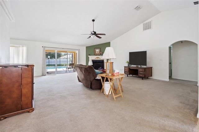 4300 NW 4th Cir, Ocala, FL 34475 - living room with ceiling fan, light carpet, arched walkways, a fireplace, and high vaulted ceiling