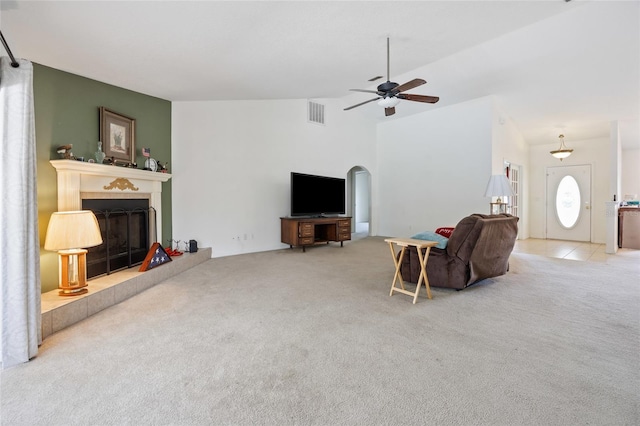 4300 NW 4th Cir, Ocala, FL 34475 - living area featuring carpet, a tile fireplace, ceiling fan, arched walkways, and lofted ceiling