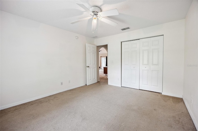 4300 NW 4th Cir, Ocala, FL 34475 - unfurnished bedroom featuring carpet floors, a closet, ceiling fan, and arched walkways