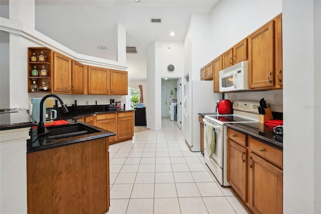 4300 NW 4th Cir, Ocala, FL 34475 - kitchen featuring white appliances, dark countertops, light tile patterned floors, brown cabinetry, and open shelves