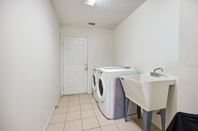4300 NW 4th Cir, Ocala, FL 34475 - washroom with separate washer and dryer and light tile patterned floors