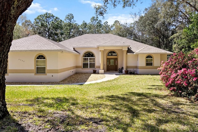 4322 N Mayan Dr, Hernando, FL 34442 - view of front of home featuring stucco siding, a front lawn, and roof with shingles