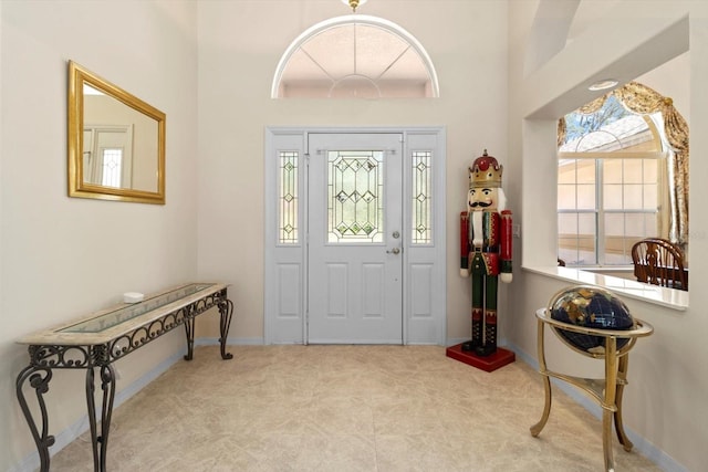 4322 N Mayan Dr, Hernando, FL 34442 - carpeted entryway featuring baseboards and a towering ceiling
