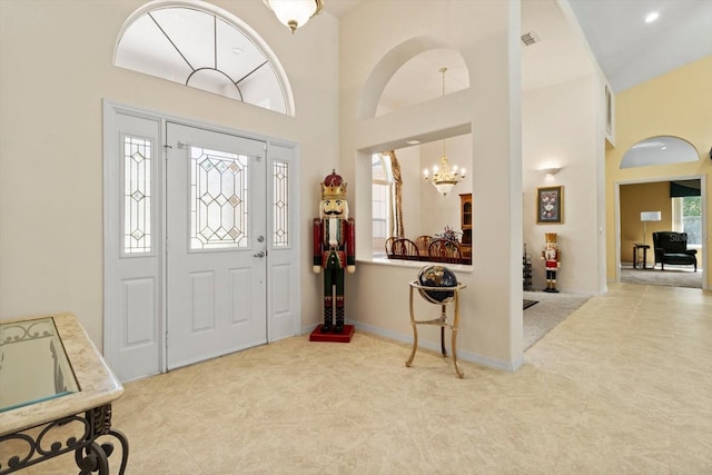 4322 N Mayan Dr, Hernando, FL 34442 - foyer entrance featuring carpet flooring, a chandelier, and a high ceiling