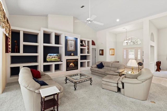 4322 N Mayan Dr, Hernando, FL 34442 - living area with carpet, high vaulted ceiling, arched walkways, ceiling fan, and a glass covered fireplace