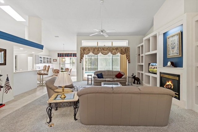 4322 N Mayan Dr, Hernando, FL 34442 - carpeted living room with a glass covered fireplace, ceiling fan, and vaulted ceiling