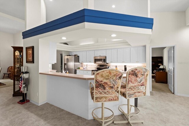 4322 N Mayan Dr, Hernando, FL 34442 - kitchen featuring stainless steel appliances, light carpet, white cabinets, light countertops, and recessed lighting