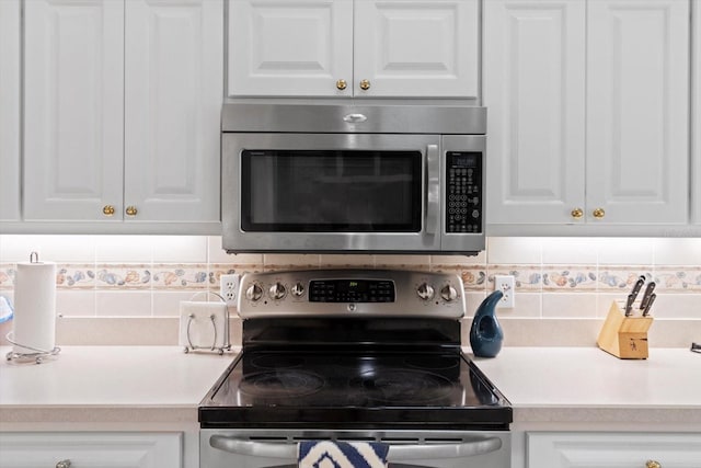 4322 N Mayan Dr, Hernando, FL 34442 - kitchen with appliances with stainless steel finishes, white cabinets, and decorative backsplash