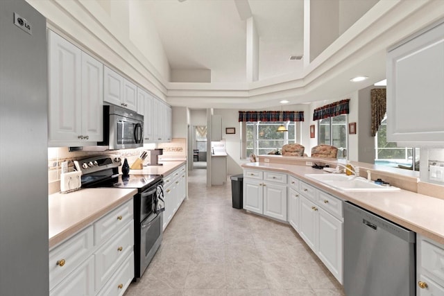 4322 N Mayan Dr, Hernando, FL 34442 - kitchen with stainless steel appliances, plenty of natural light, light countertops, white cabinetry, and recessed lighting