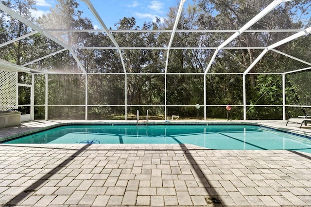 4322 N Mayan Dr, Hernando, FL 34442 - outdoor pool featuring a patio, glass enclosure, and view of scattered trees