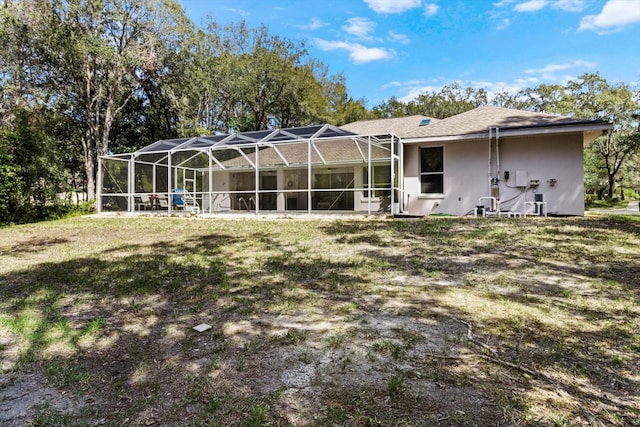 4322 N Mayan Dr, Hernando, FL 34442 - back of house featuring stucco siding, a lawn, and a lanai