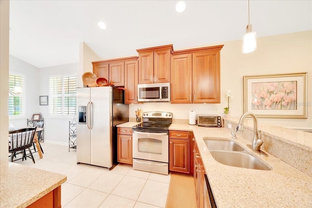 814 Copperhead Cir, Saint Augustine, FL 32092 - kitchen featuring appliances with stainless steel finishes, vaulted ceiling, light tile patterned floors, decorative light fixtures, and light stone countertops