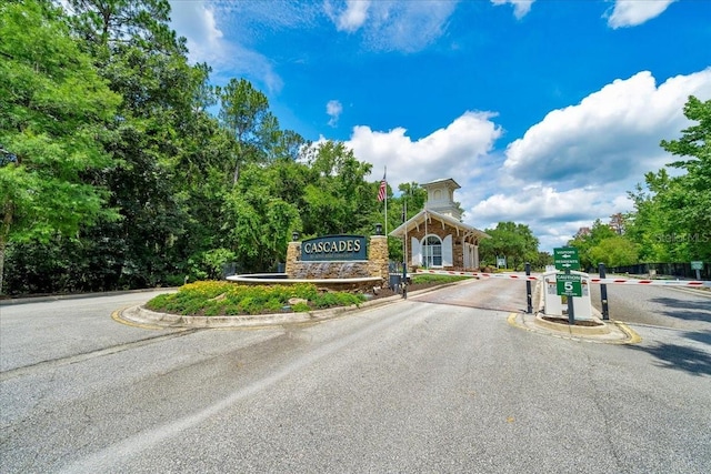 814 Copperhead Cir, Saint Augustine, FL 32092 - view of asphalt road with curbs and a gated entry