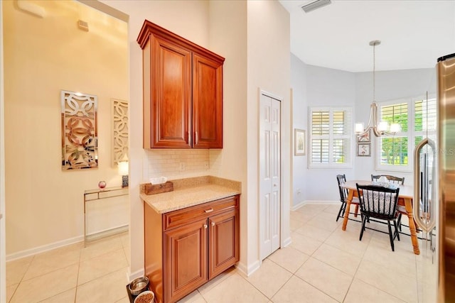 814 Copperhead Cir, Saint Augustine, FL 32092 - kitchen featuring a chandelier, decorative backsplash, light tile patterned floors, pendant lighting, and stainless steel fridge
