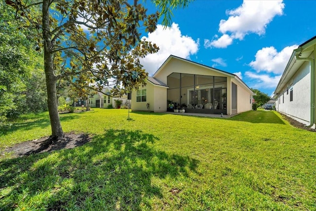 814 Copperhead Cir, Saint Augustine, FL 32092 - rear view of property featuring a lawn, a sunroom, and stucco siding