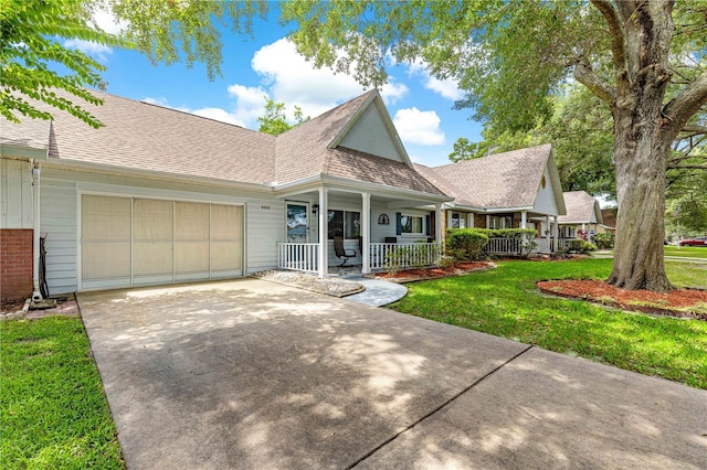 8400 SW 90th St Unit C, Ocala, FL 34481 - view of front facade featuring covered porch, driveway, a garage, a front lawn, and roof with shingles