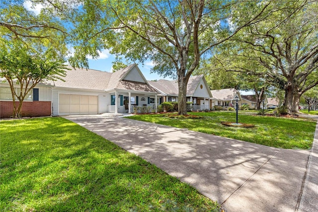 8400 SW 90th St Unit C, Ocala, FL 34481 - view of front facade with covered porch, concrete driveway, an attached garage, and a front lawn