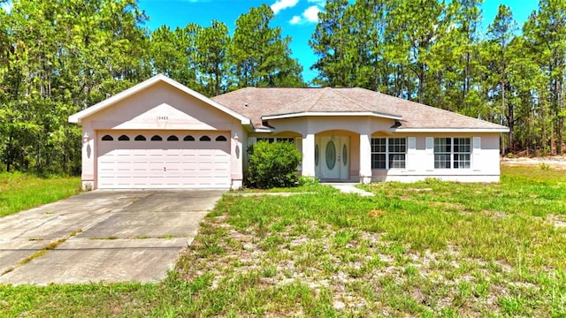 15483 Penn State Rd, Weeki Wachee, FL 34614 - ranch-style house featuring an attached garage, driveway, and stucco siding
