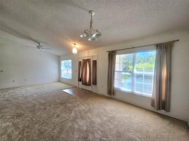15483 Penn State Rd, Weeki Wachee, FL 34614 - unfurnished room with a textured ceiling, carpet floors, a chandelier, and a ceiling fan
