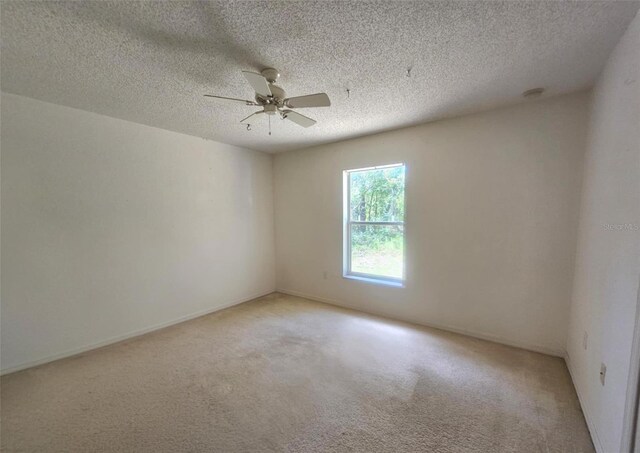 15483 Penn State Rd, Weeki Wachee, FL 34614 - empty room featuring ceiling fan, light carpet, and a textured ceiling