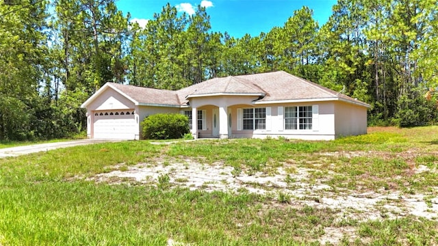 15483 Penn State Rd, Weeki Wachee, FL 34614 - single story home with an attached garage, concrete driveway, stucco siding, and a front lawn