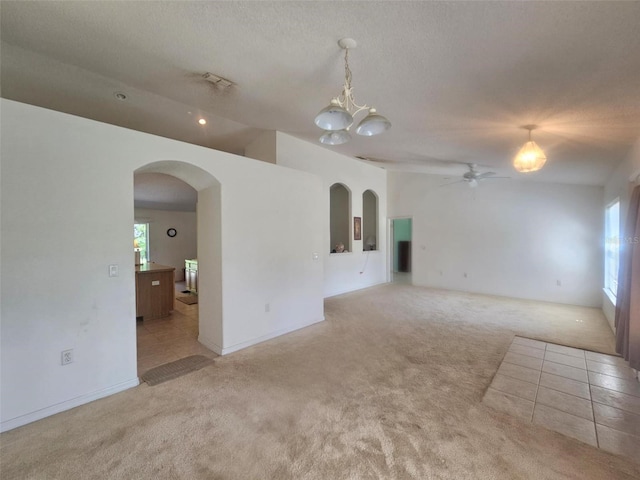 15483 Penn State Rd, Weeki Wachee, FL 34614 - spare room featuring light carpet, arched walkways, a ceiling fan, plenty of natural light, and lofted ceiling