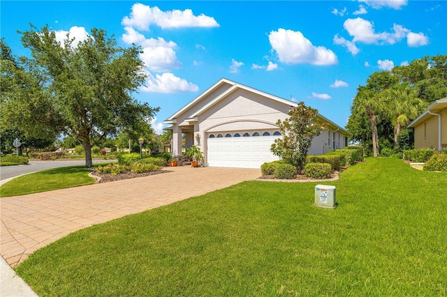 8566 SW 83rd Loop, Ocala, FL 34481 - single story home with decorative driveway, a front lawn, an attached garage, and stucco siding