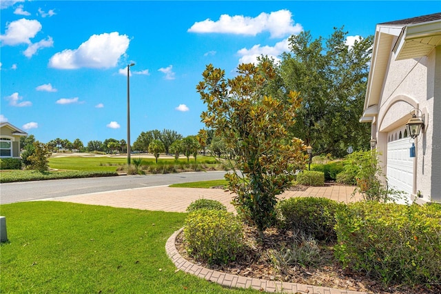 8566 SW 83rd Loop, Ocala, FL 34481 - view of home's community featuring a garage and a lawn