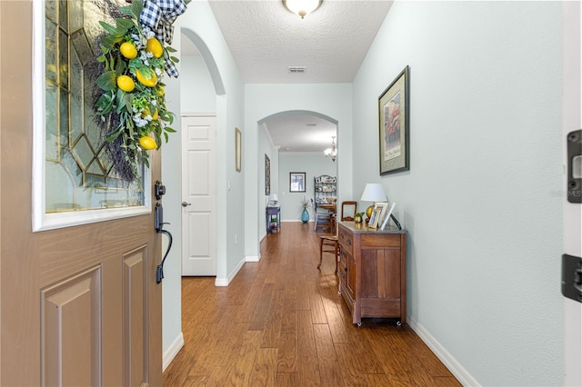 8566 SW 83rd Loop, Ocala, FL 34481 - foyer entrance with wood finished floors, arched walkways, and a textured ceiling
