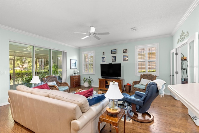 8566 SW 83rd Loop, Ocala, FL 34481 - living room featuring a ceiling fan, ornamental molding, and light wood-type flooring