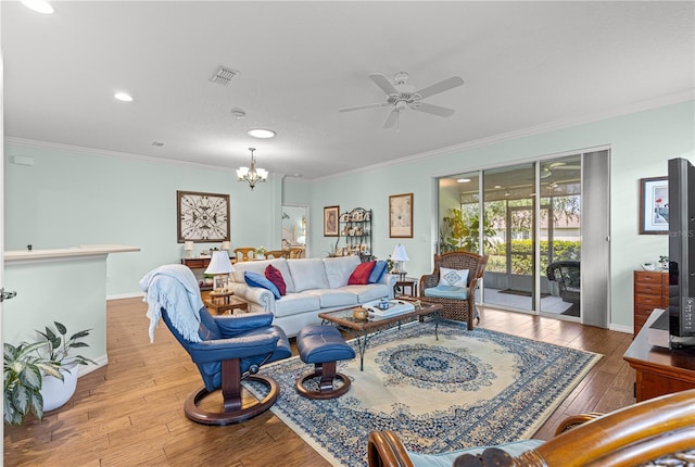 8566 SW 83rd Loop, Ocala, FL 34481 - living room featuring crown molding, a ceiling fan, a chandelier, hardwood / wood-style flooring, and recessed lighting