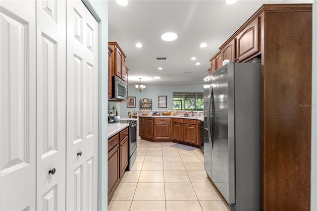 8566 SW 83rd Loop, Ocala, FL 34481 - kitchen featuring stainless steel appliances, light countertops, light tile patterned flooring, recessed lighting, and a chandelier