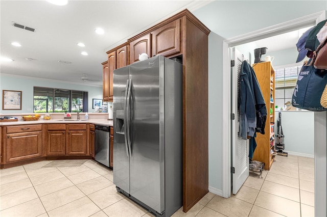 8566 SW 83rd Loop, Ocala, FL 34481 - kitchen featuring appliances with stainless steel finishes, crown molding, light tile patterned flooring, light countertops, and recessed lighting