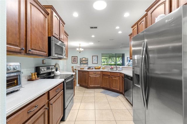 8566 SW 83rd Loop, Ocala, FL 34481 - kitchen with stainless steel appliances, light countertops, light tile patterned flooring, recessed lighting, and brown cabinetry